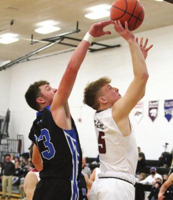 Arapahoe’s Nolan Meyers deflects a shot attempt from HiLine’s Cooper Ray.