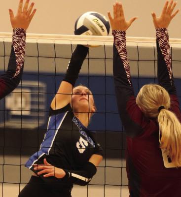 Desi Farner (above) attacks while Ruby McCune and Cydney Carlson (below) block an attack.