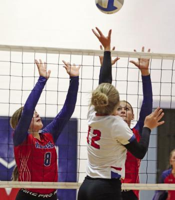 Medicine Valley’s Kenley Cole and Oakley Stout go up for a block.