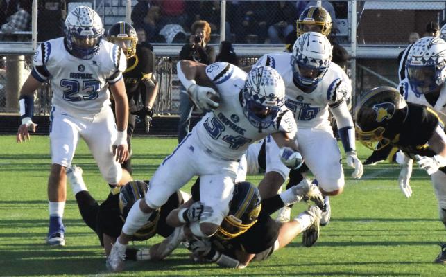 Arapahoe’s Garyson Koller tries to break free from an SRC tackler.