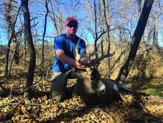 Brian Ballou with his white tail buck.