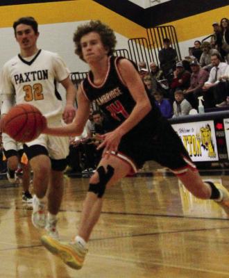 Cambridge’s Brady Ahlemeyer bounds to the hoop after stealing the ball from Paxton and making a breakaway.
