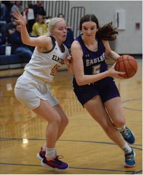 The Eagles’ Tori Bose rolls to the rim for a layup.