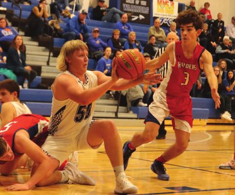 Arapahoe’s Cooper Wendland saves a loose ball and dishes to a teammate.