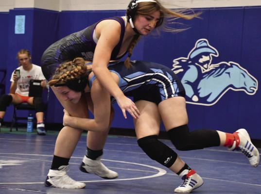 Southwest’s Aubrie Seybould shoots for a takedown.