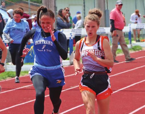 ABOVE: Cambridge’s Paige Sickels swept titles in the 100, 200 and 400 at the District D7 Meet to qualify for State in each race. BELOW LEFT: Southwest’s Jake O’Dea and Cambridge’s Shane Horwart congratulate each other at the finish of the 3,200 run where O’Dea earned an automatic bid to State by finishing second and Horwart earned a bid via wild card. BELOW RIGHT: Arapahoe’s Austin Warburton sprints to the finish in the 100 dash, where he finished eighth.