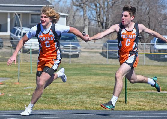 Cambridge’s Tate Koeppen receives a handoff from the Trojans’ Henry Shoemaker.