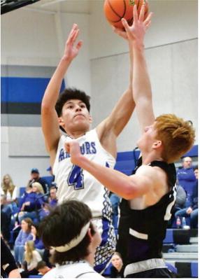 Arapahoe’s Alex Diaz rises for a jumper over Southern Valley’s Tylor Grove.