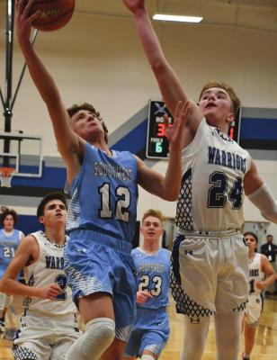 Southwest’s Trenton Williams goes in for a layup against Arapahoe’s Trenton Roskop.