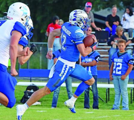 Cambridge’s Trenton Roskop takes off for a long touchdown run on the first play of the game Friday night against Bertrand.