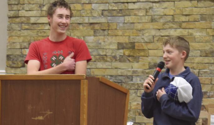Teen Council Members David Beck and Dylan Wendell lead those attending the 4-H Achievement Banquet with the reciting of the 4-H Pledge and the Flag Salute.