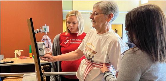 Mary Alexander does occupational therapy with help from staff at Tri Valley Health System as part of her recovery.