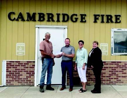 Farmer’s mutual gifts donation Checks to Cambridge and arapahoe Volunteer Fire departments