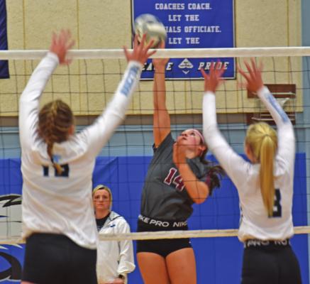 The Bulls’ Zoey Evans attacks a ball against Overton.