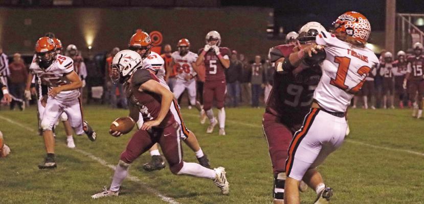 Hi-Line’s Zach Whittaker weaves thru traffic with the help of a crushing block from Drew Knoerzer.