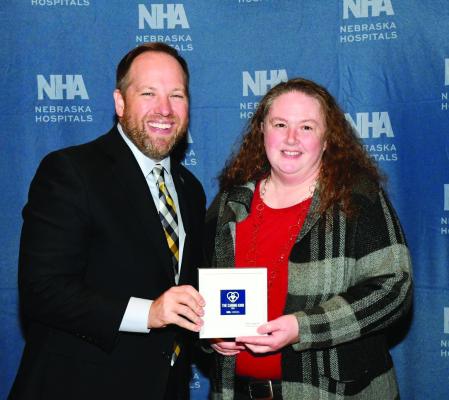 Nebraska Hospital Association President Jeremy Nordquist presents the Caring Kind Award to Tri Valley Health System’s Dr. Shiuvaun Jaeger at the Nebraska Hospital Conference last week.