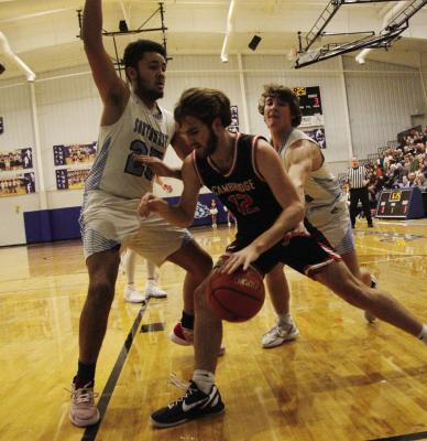 Cambridge’s Krayton Ruggles drives baseline against Southwest defenders Trenton Williams and Jakub Walz.