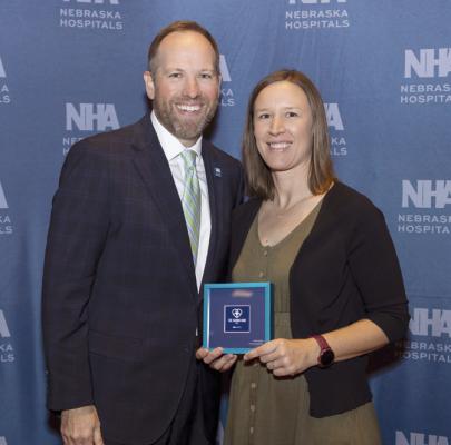 Nebraska Hospital Association President Jeremy Nordquist is pictured presenting the Caring Kind Award to Katie Brooks, OT, Tri Valley Health System’s Honoree, at the Nebraska Hospital Conference.