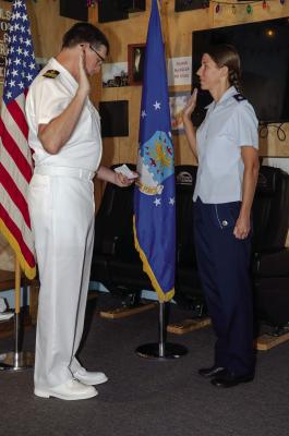 Bill Weidenhammer, USN, Ret. administers the USAF Oath of Office to Lt. Col. Bethany G. Foley.