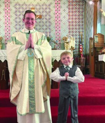 Sunday, April 12th First Communion was celebrated at St. Germanus in Arapahoe. Pictured: Rev. Kenneth J. Wehrs and Theo tenBensel.