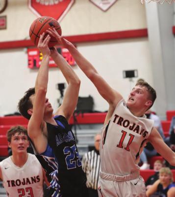 Cambridge’s Carson Trompke rises to block the jumper of Arapahoe’s Tyler Miller.