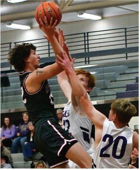 Hi-Line’s Dawson Ruda tries to score inside against a shot challenge from Southern Valley’s Tylor Grove and Tate Weatherwax.