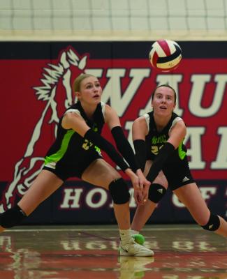 MHC’s Addison Richards and Caylie Softley combine for a serve recption.
