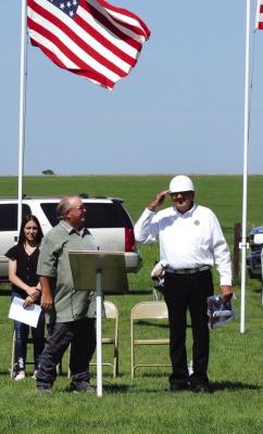 Ron Ludeke gives the crowd a little salute after being honored for 48 years with the Oxford American Legion, the last ten of those as post commander. He was given a flag and thanks during the Memorial Day services at the Oxford Cemetery. Also recognized was Wayne Cowan for 50 years with the Oxford Legion. Cowan was unable to make the trip from Florida to attend. Pictured are Mike Quinn and Ron Ludeke.