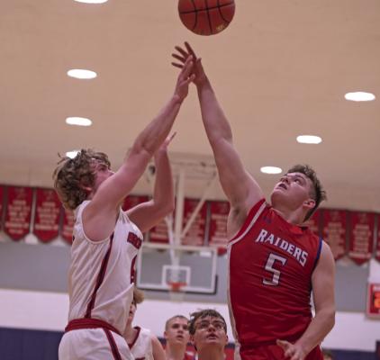 The Raiders’ Austin Roblee challenges a jumpshot.