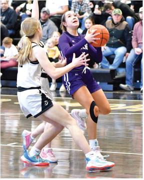 Southern Valley’s Vanesa Aguayo (above) and Tori Bose (below) rise for shots at the rim.