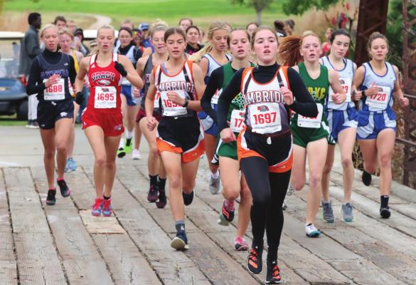 ABOVE: Cambridge’s Brenna Deterding leads the pack of runners a quarter-mile into Thursday’s district meet. BOTTOM LEFT: Arapahoe’s Jacob Moore and Cambridge’s Gavin Gunderson pass the two-mile mark. BOTTOM RIGHT: Hi-Line’s Whitney Dickau moves into medal position.