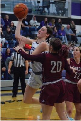 Southern Valley’s Ann Bose (above) and Adi Hunt (below) score in the lane.