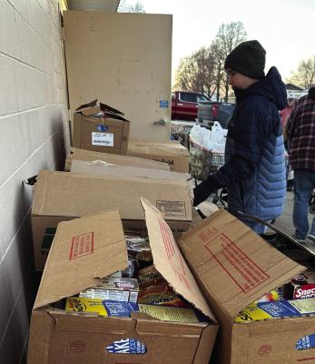 Volunteers pack boxes of food and toys for last year’s Lions Christmas Project.