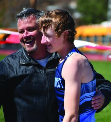 Southwest’s Gage Hammond celebrates a new personal-best - and automatic qualifying height - in pole vault with his coach Rudy Kennedy.