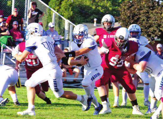 Arapahoe’s Tristian White weaves through traffic at the line of scrimmage during Friday’s victory at Hi-Line.