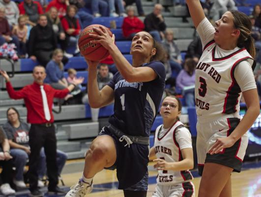 Southwest’s Asia Gallegos rolls to the rim for a layup against Decatur Community Schools of Oberlin in Saturday’s Cattle Trail Tournament championship game.