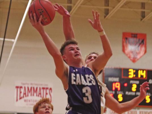 ABOVE: Brody Yant rises for a layup under a DCS shot blocker. BELOW: Clayton Berry wraps a pass around a defender to an open shooter in the corner.