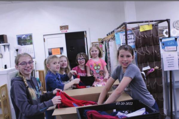 It was heartwarming to see these five young girls working together as they packed children's clothing for Orphan Grain Train. Enjoying the project were (l-r) Briar Gunderson, Claire Nickerson, Rachel, Lydia and Mary McGowen and Dakota Deterding.