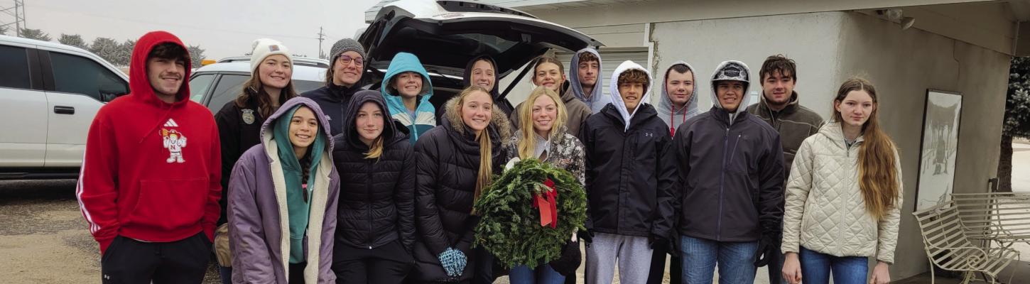 Cambridge High School students laid wreaths on veterans’ graves on a cold and icy morning.