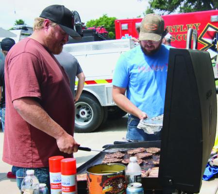 The Bartley Fire Department and EMS grill burgers for the community at the town Fire Barn.