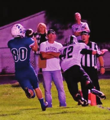 ABOVE: Cambridge’s CJ Fiene makes a catch and turns up field aginst Amherst Friday night. BOTTOM: Arapahoe’s Tyler Miller snags a two-point conversion that puts the Warriors in front of Lawrence-Nelson for good Friday night.