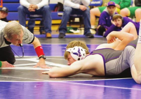 ABOVE: Southern Valley’s Trevor Brownpins his opponent. BOTTOM LEFT: Cambridge’s Adam Corbett runs a cradle. BOTTOM RIGHT: Arapahoe’s Tristian White earns a pin.