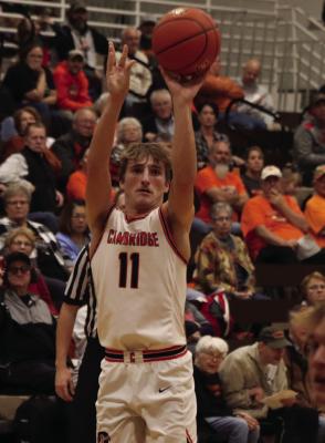 The Trojans’ Carson Trompke buries a three from the wing.