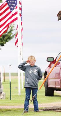 At Memorial Day Services held in Bartley Monday morning, a program was held at Southwest High School’s Auditorium, where George Probasco (pictured below) was the featured speaker. Probasco delivered a message on the importance of remembering our fallen heroes, but also the importance of continuing to serve. Pictured above is a young man at attention while taps was played at the Bartley Cemetery.