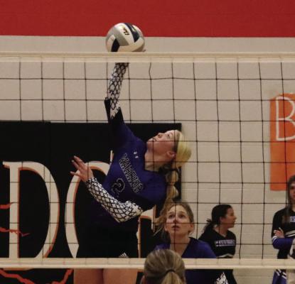 Arapahoe’s Emerson Swanson swats an attack from the pin.