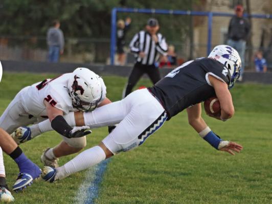 Arapahoe’s Kade Fisher dives across the goal line.
