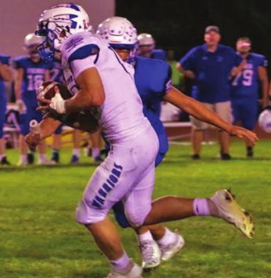 Arapahoe’s Colton Carlson looks for running room.