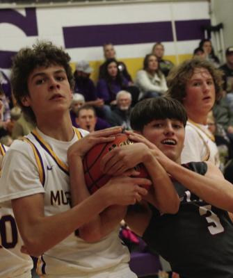 The Bulls’ Treyton Evans fights for a loose ball that ends in a held ball.