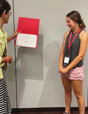 Haiden Garey presented with the Certificate of Participation from Associate Dean and 4-H Program Leader, Kathleen Lodl.