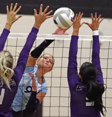Southwest’s Annika Nelms smashes a kill between blockers.